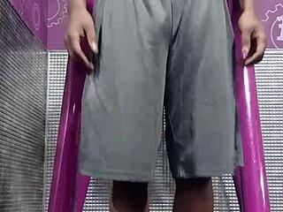 athletic brunette uses machine in dorm workout room