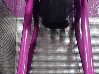 athletic brunette uses machine in dorm workout room