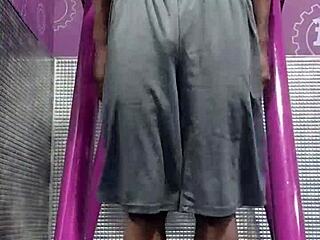 athletic brunette uses machine in dorm workout room