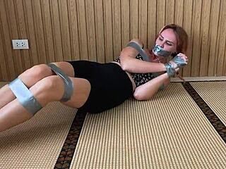 Check out this redhead's sexy feet while duct-taped tight