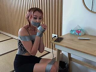 Check out this redhead's sexy feet while duct-taped tight