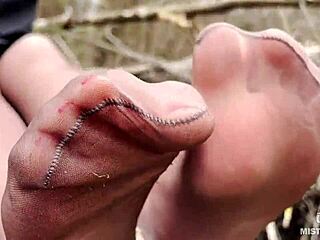 Goddess teases feet in pantyhose amid spring forest