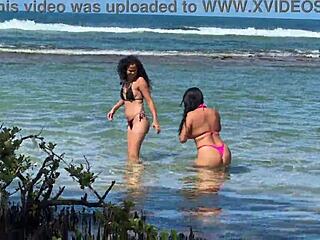 Two pretty young Latinas kiss on Enseada dos Corais beach Cabo PE