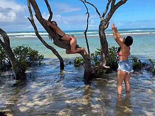 Two pretty young Latinas kiss on Enseada dos Corais beach Cabo PE