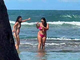 Two pretty young Latinas kiss on Enseada dos Corais beach Cabo PE