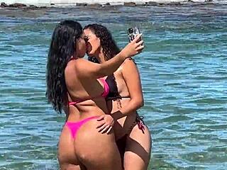 Two pretty young Latinas kiss on Enseada dos Corais beach Cabo PE