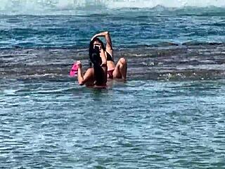 Two pretty young Latinas kiss on Enseada dos Corais beach Cabo PE