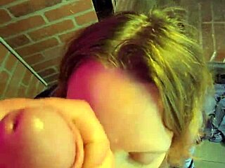 chained milf kneels gagging on cock cum covered