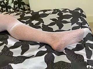 brunette teases her slit in fishnet lingerie close-up