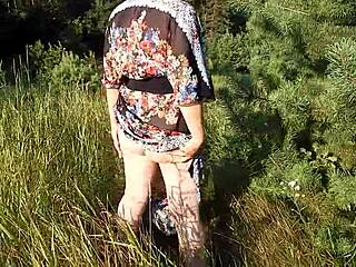 hairy mature flashes her chubby beaver through see-through skirt on nudist beach