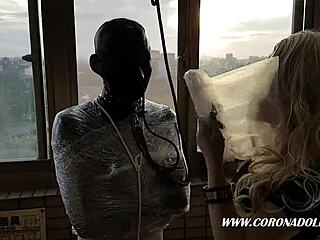 bondage babe in 1mm rubber mask and latex catsuit mummified outdoors