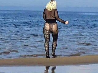 black style flashing on the beach in pantyhose