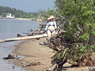mature blondes walk on the beach in bikinis